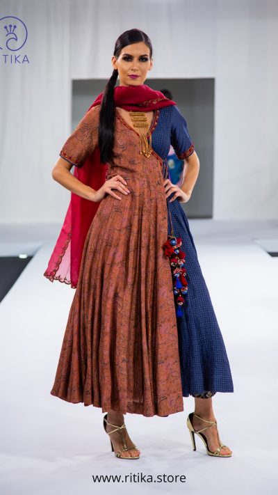 Kalamkari angrakha with munga checks and handmade tassles, teamed up with organza duppatta with aari work.