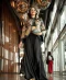 Black and gold embroidered jacket paired with flowing black skirt