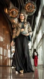 Black and gold embroidered jacket paired with flowing black skirt