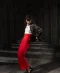 Black floral embroidered cropped jacket styled with red wide-leg trousers