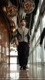 Black men's embroidered short jacket with draped trousers