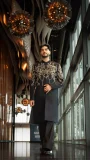 Black men's sherwani with intricate gold floral embroidery