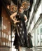 Black sleeveless embellished dress with gold motifs and side slit