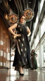 Black sleeveless embellished dress with gold motifs and side slit