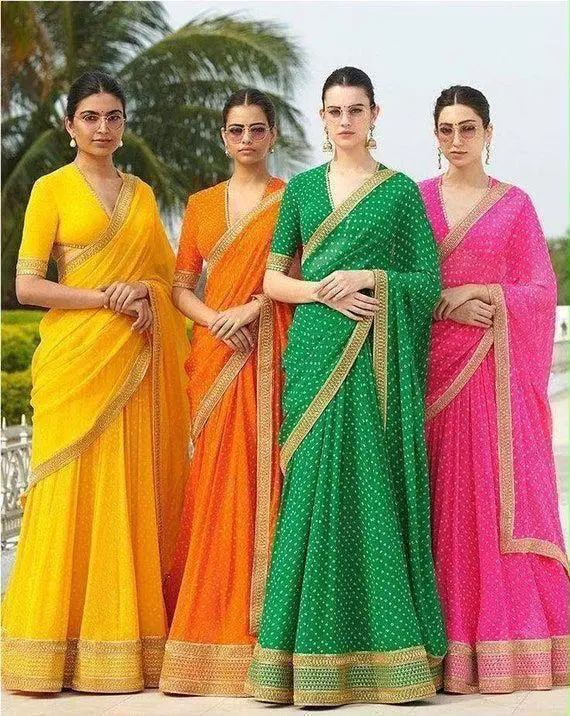 Four sarees in yellow, orange, green and pink